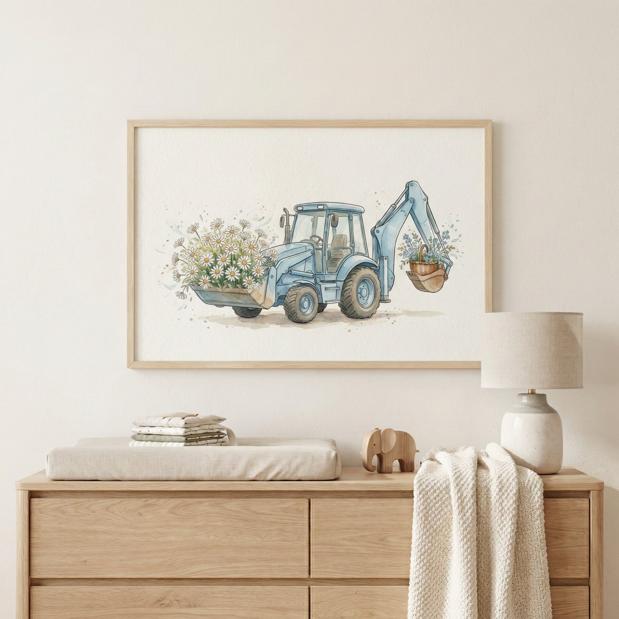 Whimsical nursery wall art showing a blue backhoe holding white daisies and a basket of flowers, mounted above a changing station with soft-toned furniture and decor.
