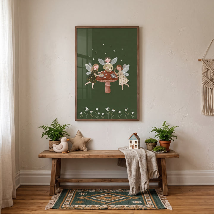 Framed baking mushroom garden fairies wall art hangs above a wooden bench with plants, toys, and a throw blanket.