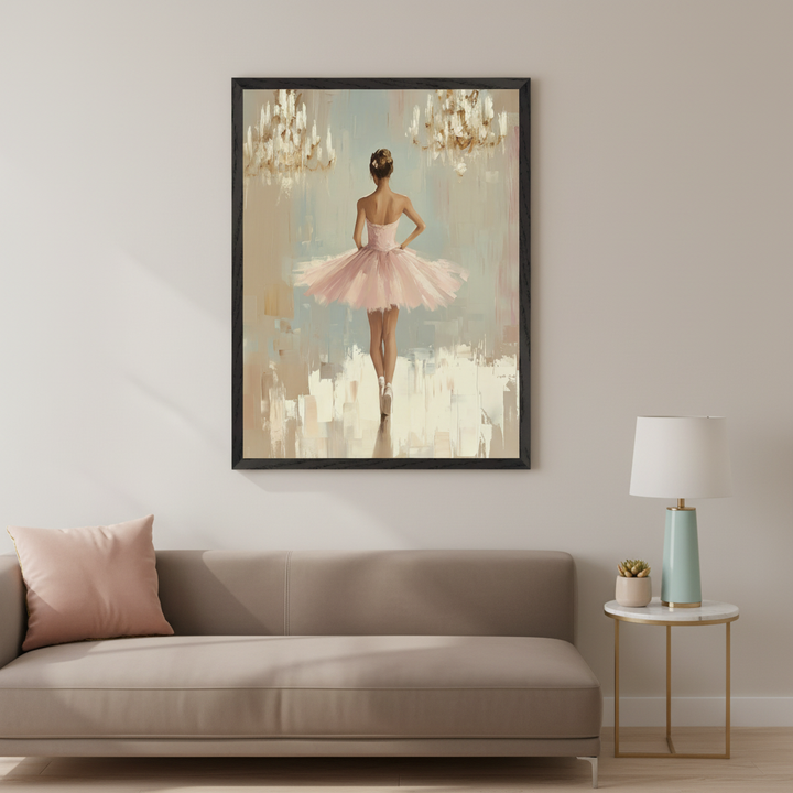 Modern living room with a light brown sofa. A large black-framed impressionistic painting of a ballerina in a pink tutu, seen from the back, en pointe, under two chandeliers, hangs above the sofa. A side table with a lamp is next to the sofa.