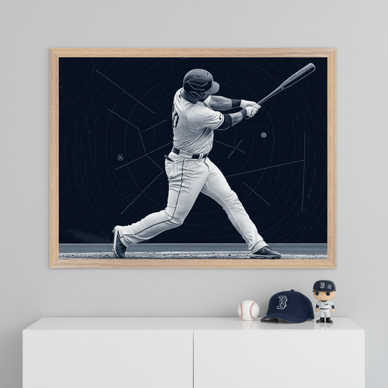 Modern room with white credenza. Framed monochrome print of a baseball player mid-swing against a schematic background hangs above it. On credenza: a baseball, navy 'B' cap, and baseball player Funko Pop figure.