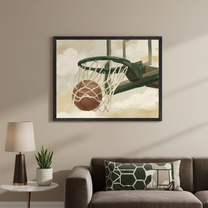 Modern living room with a brown sofa, side table, lamp, and plant. A framed painterly artwork of a basketball falling through a hoop hangs above the sofa.