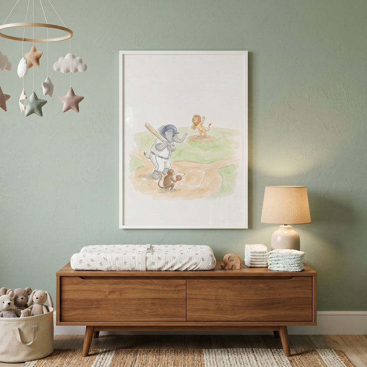 Batting animals wall art hangs above a wooden dresser in a green nursery with a star mobile and basket of plush toys.