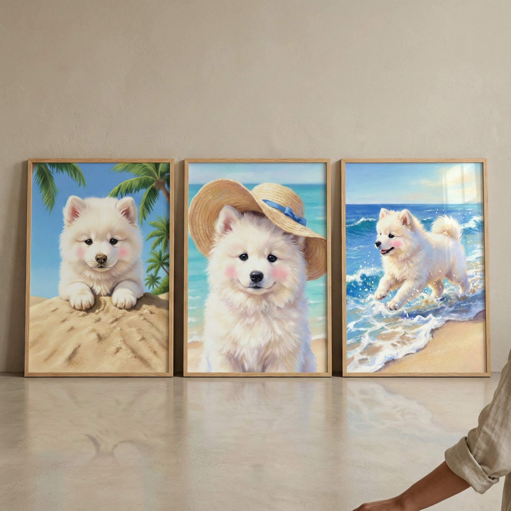 Three framed vertical artworks are displayed side-by-side on a neutral wall. They feature a cute, fluffy white puppy with rosy cheeks in different beach scenes. In the left frame, the puppy lies on a sand dune with palm leaves. The middle frame shows the puppy wearing a straw sun hat with a blue ribbon against an ocean backdrop. In the right frame, the puppy runs through ocean waves on a beach. The illustrations are soft and vibrant. A person's arm is partially visible in the bottom right corner.