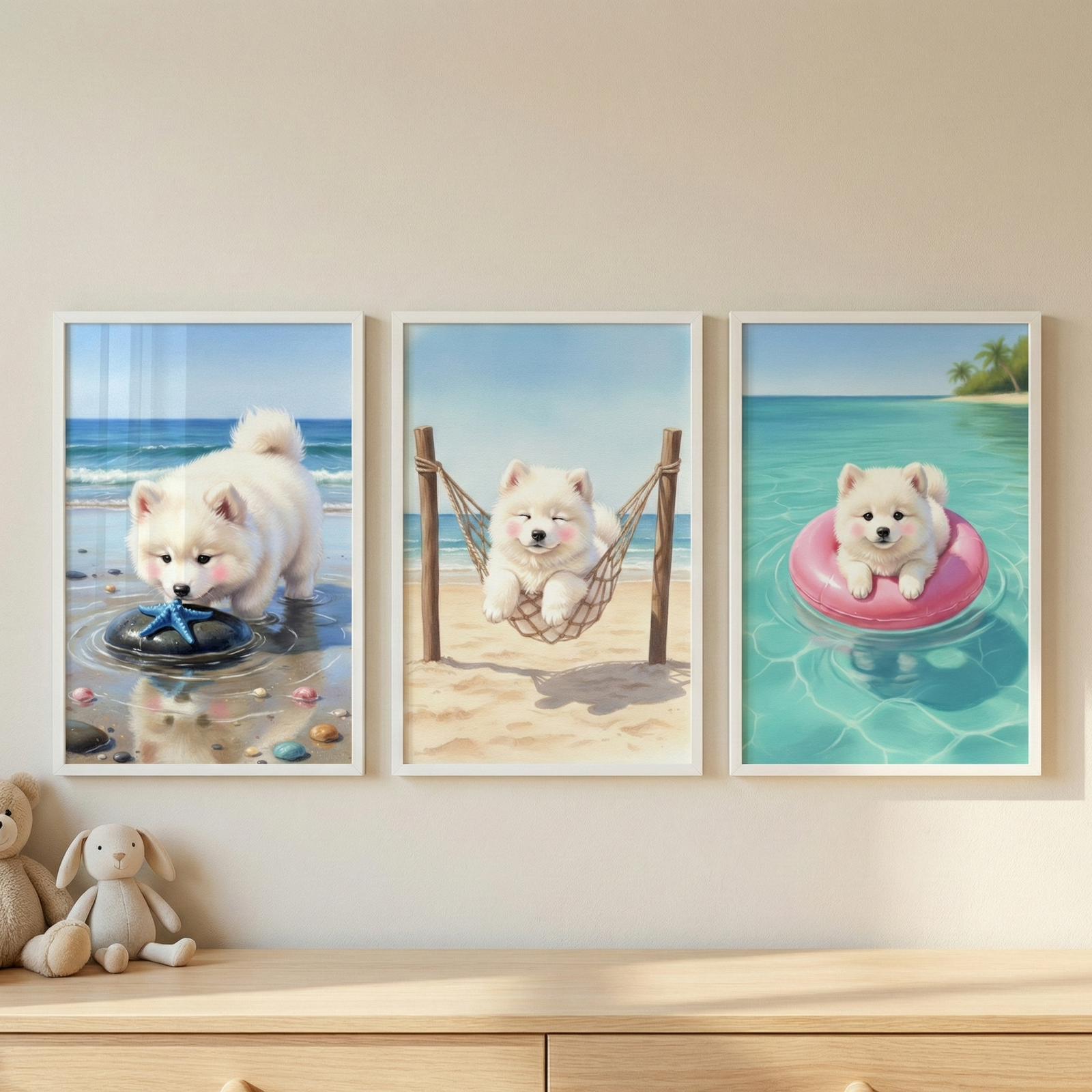 Three white-framed artworks hang in a row on a light beige wall. Each piece features a small, fluffy white puppy with pink cheeks enjoying a beach vacation. In the first, the puppy explores a blue starfish on a rock. In the second, it rests in a rope hammock on the sand. In the third, it floats on a pink inner tube in clear turquoise water. Below the art, two plush toy animals sit on a light wood dresser bathed in soft light.