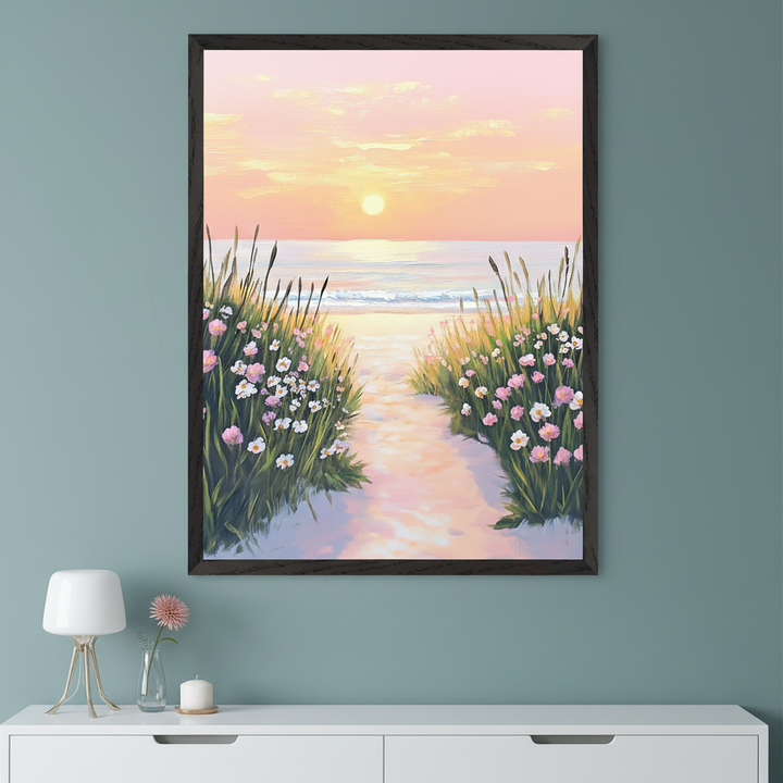 Modern room with a muted teal wall. A large framed painting of a sunset beach path with tall grass and pink and white flowers leading to the ocean hangs above a white console table.