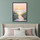 Bedroom with a beige upholstered bed. A framed painting of a sandy beach path at sunset, lined with pink and white flowers, leading to the ocean hangs centered above the bed.