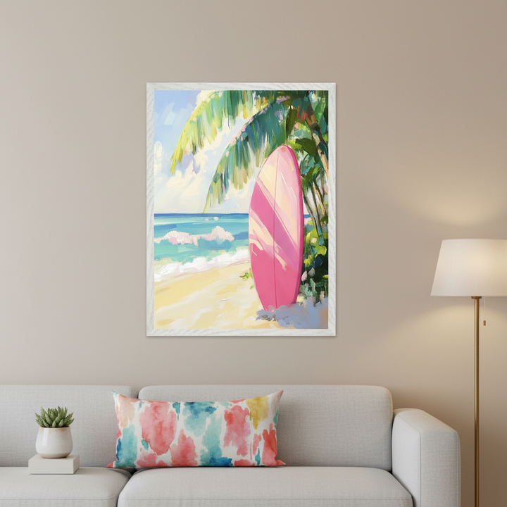 Modern living room with a light gray sofa. A large framed impressionistic painting of a pink surfboard on a sandy beach with palm trees and ocean waves hangs centered above the sofa. A white side table and a floor lamp are also visible.