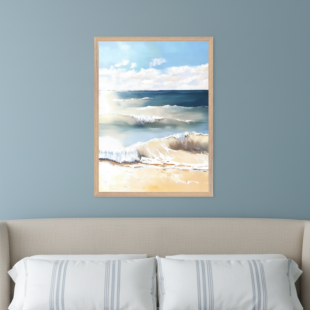 Bedroom with a beige upholstered bed and striped pillows. A framed painting of an ocean beach scene with breaking waves, a sandy shore, and a sunny blue sky hangs centered above the bed.