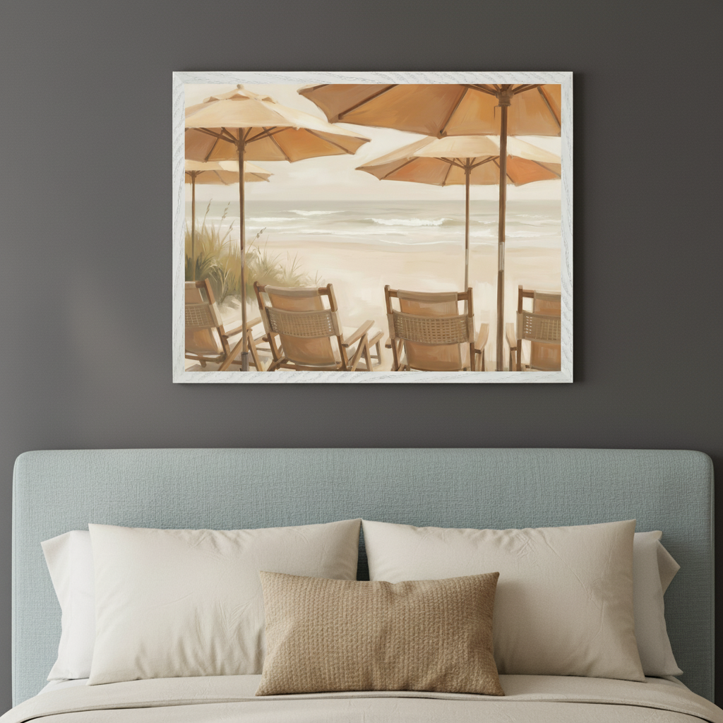 Modern bedroom with a light blue upholstered headboard. A white-framed painting of a sandy beach scene with orange sun umbrellas and empty wooden beach chairs hangs above the bed. The painting has a soft, painterly style showing waves in the background.
