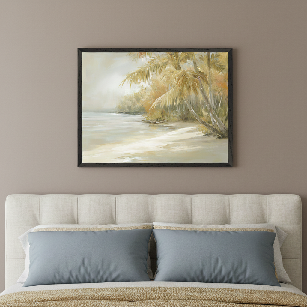 Bedroom with a tufted headboard bed, two grey pillows, and a tan blanket. A large framed painting of a sandy tropical beach with palm trees and ocean in muted, warm tones hangs centered above the bed on a taupe wall.