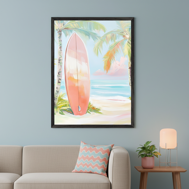 Modern living room with a beige sofa against a blue wall. A large framed painting of a coral surfboard on a sandy beach with palm trees and ocean hangs above the sofa. A patterned cushion, a potted plant, and a table lamp on a wooden side table are visible.