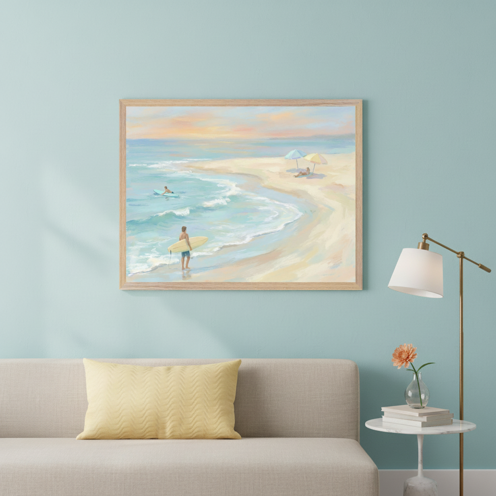 Modern living room with a light beige sofa and a brass floor lamp. A framed painterly beach scene depicting surfers and people relaxing on the sand hangs centered above the sofa.