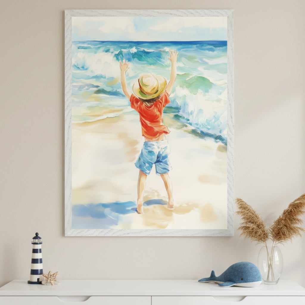 A barefoot child stands at the edge of the shore with arms lifted toward the waves, dressed in a red shirt, blue shorts, and a sun hat. The framed watercolor painting evokes a sense of wonder and freedom, set above a dresser styled with soft coastal décor.