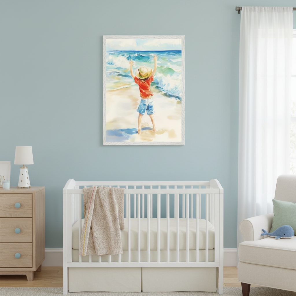 Modern nursery with a white crib, wood dresser, and cream armchair. A framed watercolor painting of a child in a straw hat with raised arms on a sandy beach with waves hangs above the crib.