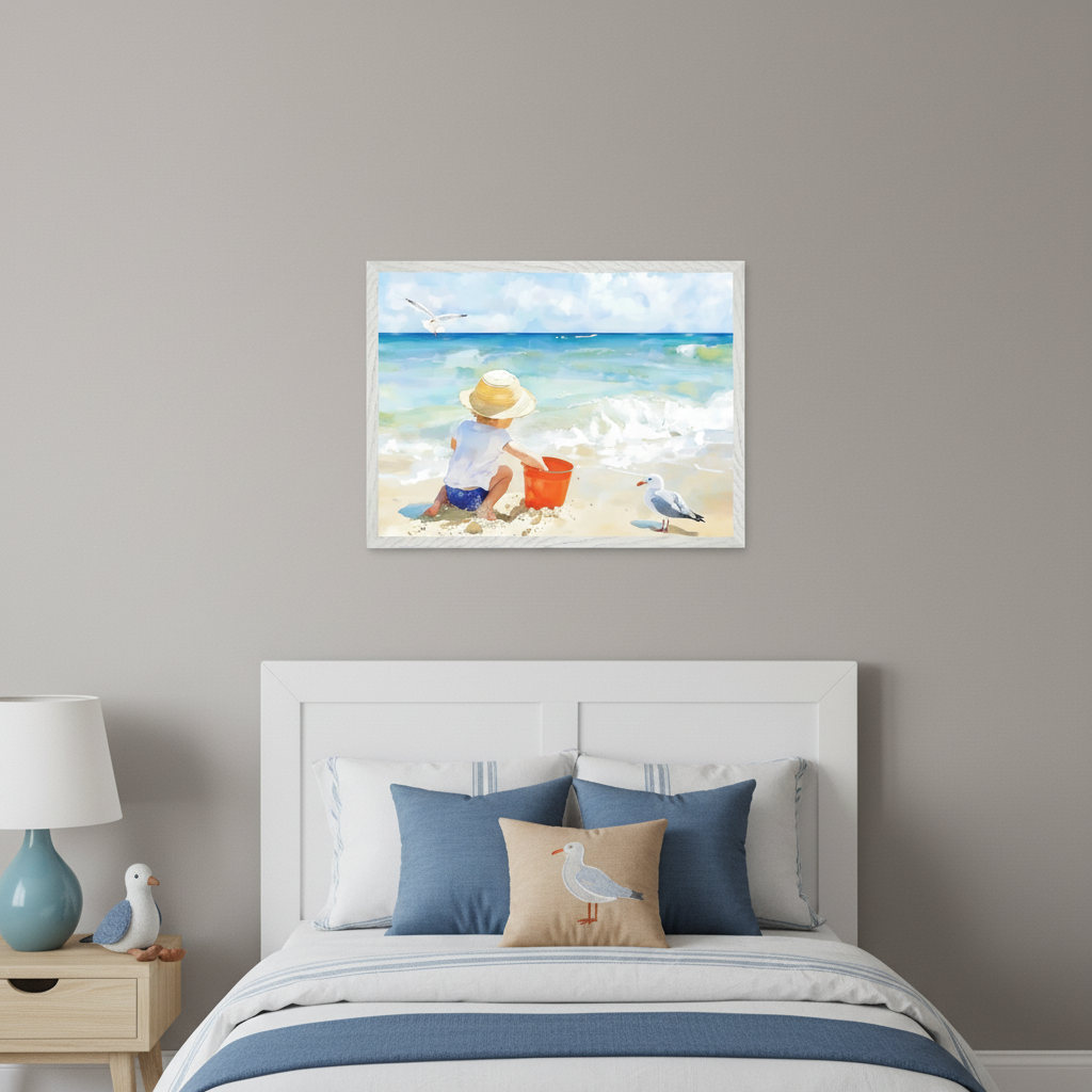 Nautical-themed kid's bedroom with a white bed and a light wood nightstand. A framed watercolor painting of a child in a hat playing in sand with a red bucket at the beach, with seagulls and the ocean, hangs centered above the bed.