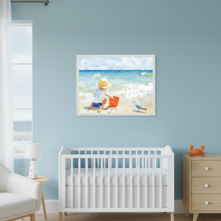 Modern nursery with a white crib and light wood dresser. A framed painterly artwork of a child playing in the sand with a red bucket at the beach, with seagulls, hangs above the crib on a light blue wall.