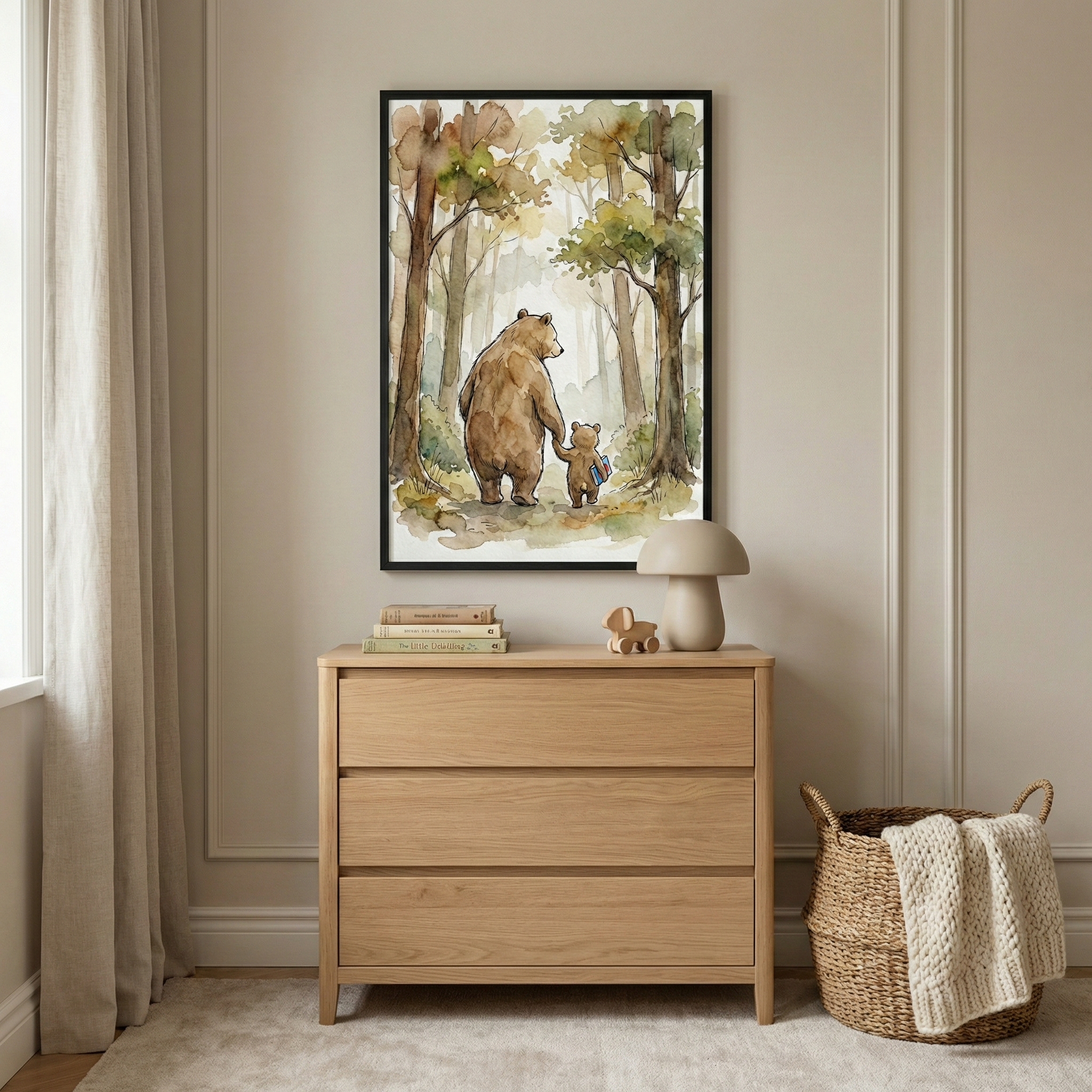 A neutral-toned room features a light wood dresser with a framed watercolor illustration hanging above it. The artwork shows a large brown bear and a small bear cub walking hand-in-paw through a soft-focus forest. On the three-drawer chest sits a stack of books, a small wooden toy, and a mushroom-shaped lamp. To the right, a woven basket holds a knit blanket. The scene is completed with light beige curtains, a plush rug, and warm beige walls with classic molding.