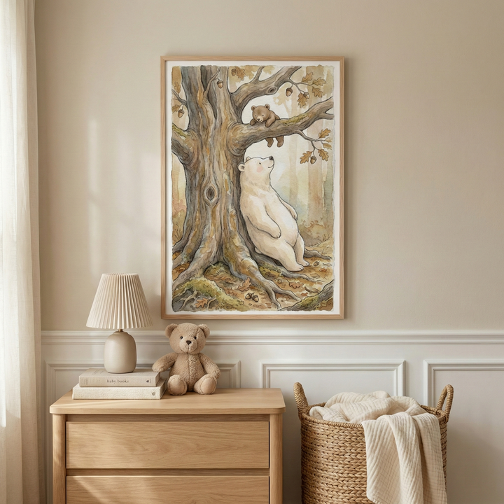A cozy nursery features a framed watercolor painting of a bear leaning against a tree, gazing up at a teddy bear perched on a branch. Below, a wooden dresser holds a beige lamp, a stuffed teddy bear, and a couple of books. A woven basket with a blanket sits beside the dresser, creating a warm, inviting atmosphere.
