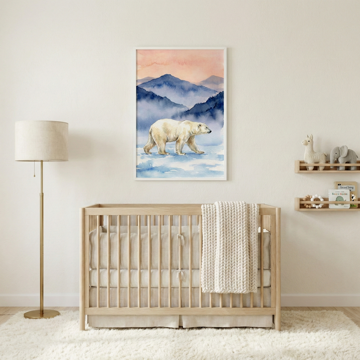 A minimalist baby nursery features a light wood crib centered against a neutral wall. A cream-colored textured knit blanket is draped over the crib's side. Above it, a large framed artwork depicts a polar bear walking on ice with blue mountains and a peach sky. To the left is a tall floor lamp with a gold-toned base and a beige drum shade. On the right, two wooden shelves hold a toy llama, an elephant, and books. A soft, high-pile white rug covers the floor, creating a cozy atmosphere.