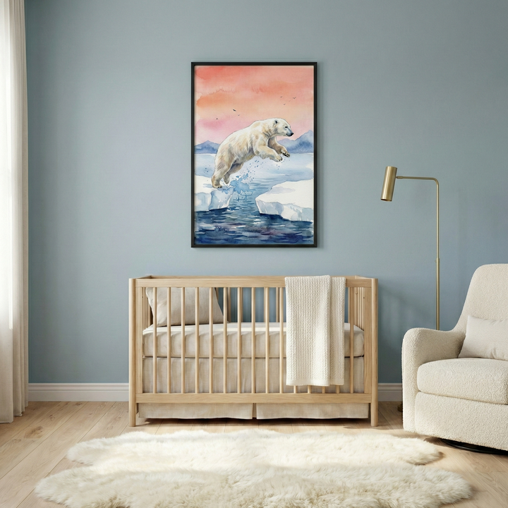 A serene and modern nursery features soft, light blue walls and a warm wood floor. Centered on the main wall is a large, black-framed watercolor-style illustration. The artwork depicts a white polar bear captured in mid-air as it jumps between two white ice floes over deep blue water. The background of the illustration shows a soft-hued sky transitioning from pale pink to orange behind distant blue mountains. 

