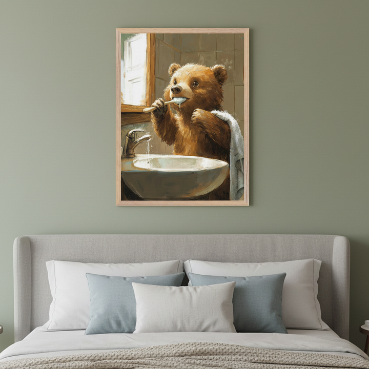 Modern bedroom with a grey upholstered bed. A framed painting of a brown bear brushing its teeth at a sink hangs centered above the headboard. The artwork is in a painterly style.