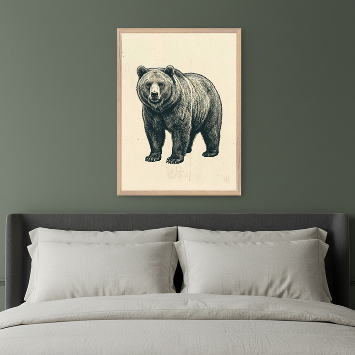 Modern bedroom with a dark gray upholstered bed and light gray bedding. A framed illustration of a grizzly bear, standing and facing forward, in a black and white sketch style on a cream background, hangs centered above the bed.