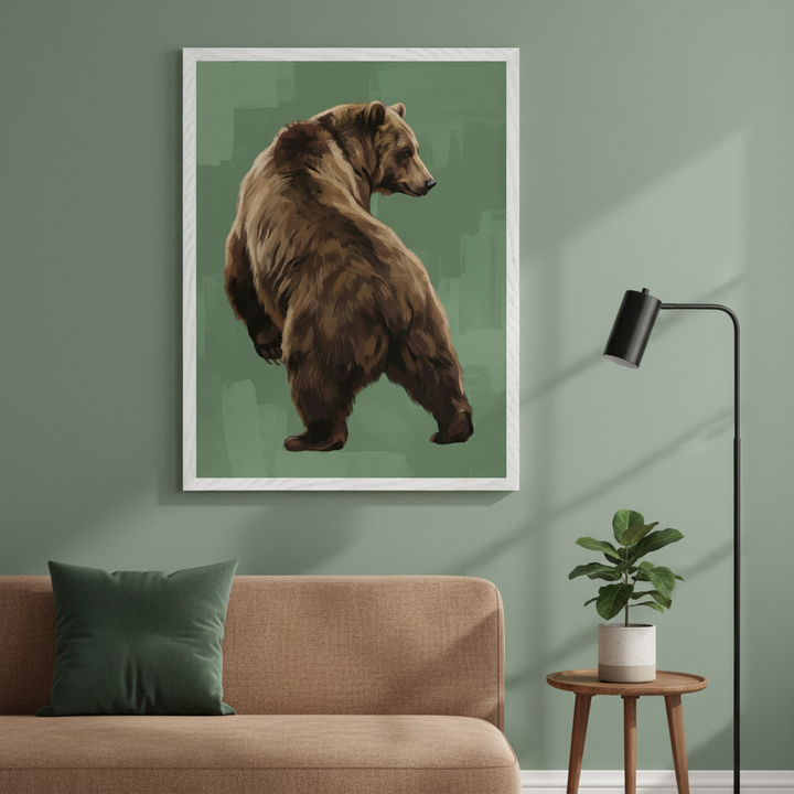 Modern living room with a brown sofa and green pillow. A large framed painting of a brown bear, back to viewer, head turned, on a textured green background, hangs above the sofa.