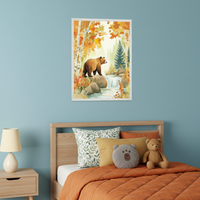 Children's bedroom with a light blue wall. A wooden bed with orange bedding and pillows sits below a large framed watercolor painting. The artwork depicts a brown bear on rocks next to a waterfall in an autumn forest. A wooden nightstand with a lamp is to the left of the bed.