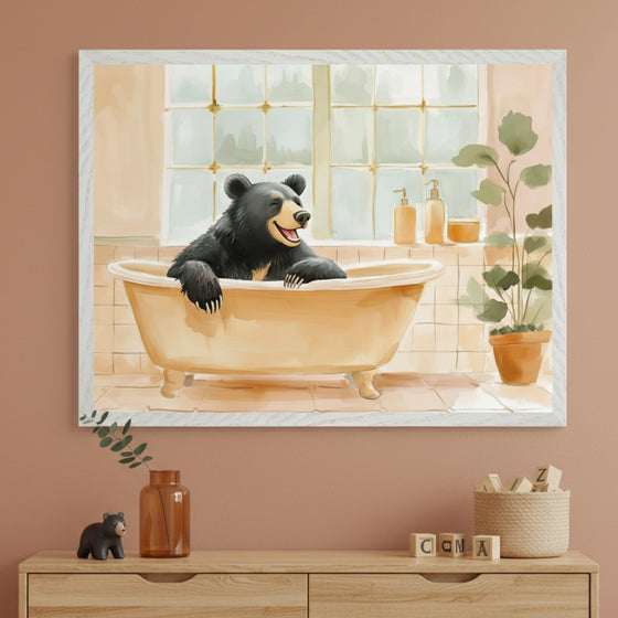 Kid's room with a light wood dresser. A large framed watercolor illustration of a smiling black bear bathing in a clawfoot tub hangs centered above the dresser.
