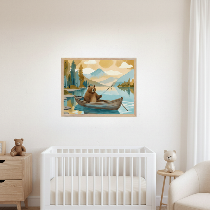 Modern nursery with a white crib, wooden dresser, and white armchair. A framed watercolor painting of a bear fishing in a boat on a lake with mountains and trees hangs centered above the crib.
