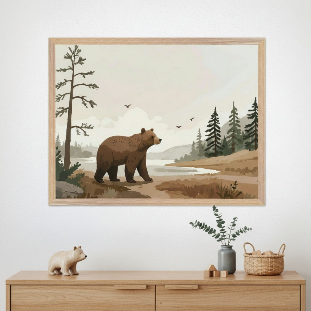 Modern nursery with a light wood dresser. A framed print of a brown bear walking by a river with evergreen trees, in an illustrative style, hangs centered above the dresser.