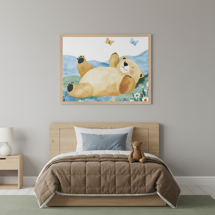 Kid's bedroom with a wooden bed, brown comforter, and nightstand. A large framed watercolor print of a happy bear lying on its back in a field with butterflies hangs above the bed.