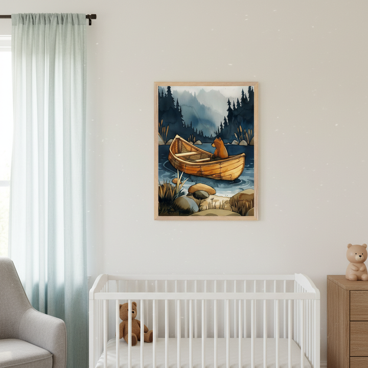 Nursery with a white crib, gray armchair, and wooden dresser. A framed watercolor painting of a bear in a wooden boat on a lake with a forest background hangs above the crib.