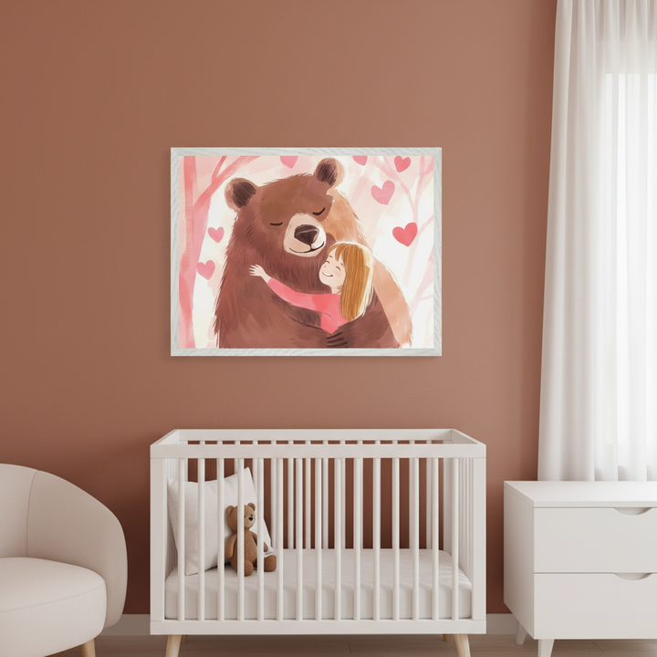 Modern nursery with warm brown walls. A white framed illustration of a brown bear hugging a smiling girl, with pink hearts and trees, hangs centered above a white crib. A cream armchair and a white dresser are also visible.