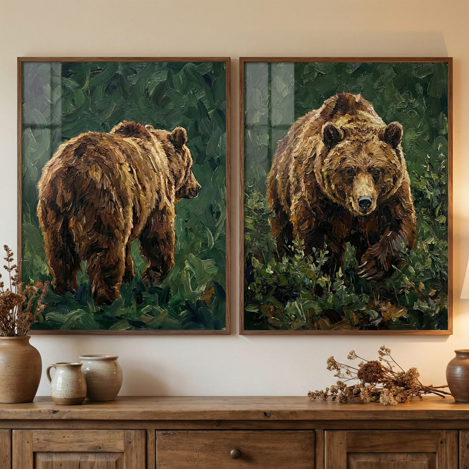 Two square framed artworks are displayed side-by-side on a light-colored wall. The piece on the left shows the rear view of a large brown bear walking into a dense green forest, while the piece on the right shows the bear facing forward, emerging from the foliage. Both works feature a heavy impasto technique with thick, expressive brushstrokes that create a rich texture. They are set in simple dark wood frames. Below the art, a rustic wooden sideboard holds ceramic pots and dried flowers.