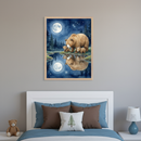Kid's bedroom with a white headboard bed, blue bedding, and brown/white pillows. A framed watercolor of a mama bear and two cubs by a moonlit, starry lake with reflections, hangs above the bed. A teddy bear and a bear-themed lamp are on a white nightstand.