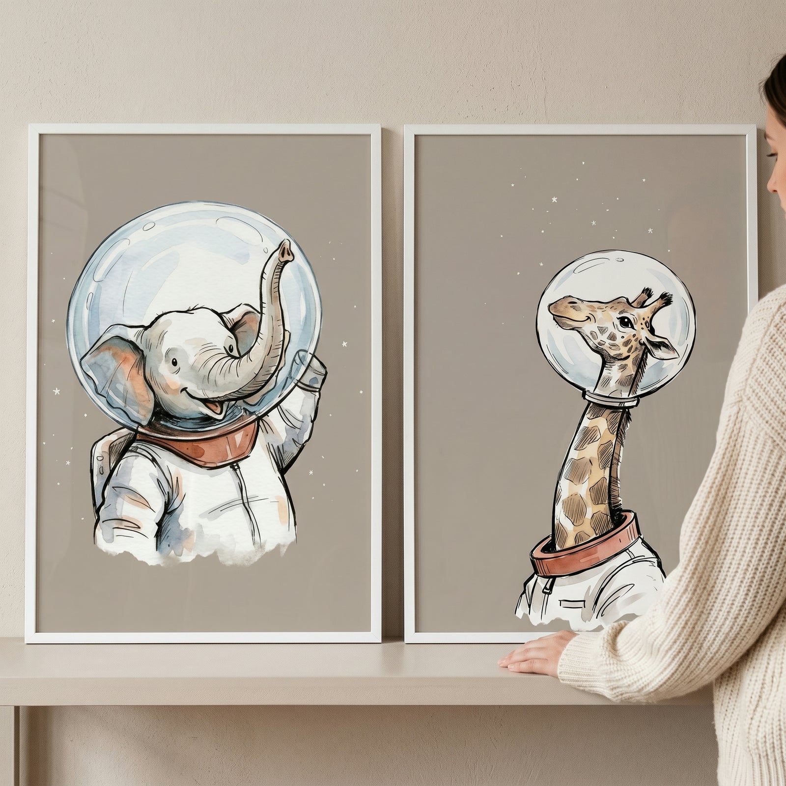 Beige cosmic astronaut animal wall art set of 2 showing an elephant and giraffe wearing space suits and bubble helmets.