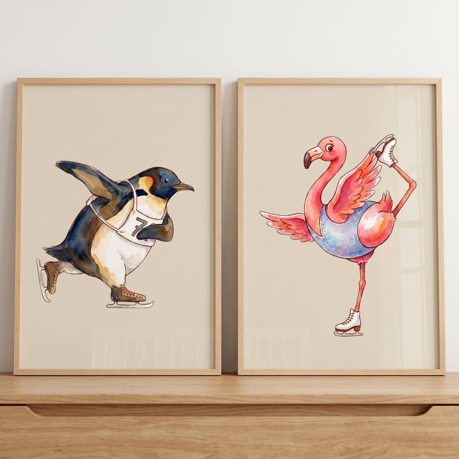 Beige watercolor skating animals wall art set of 2 with a penguin in a race bib and a flamingo in a leotard.