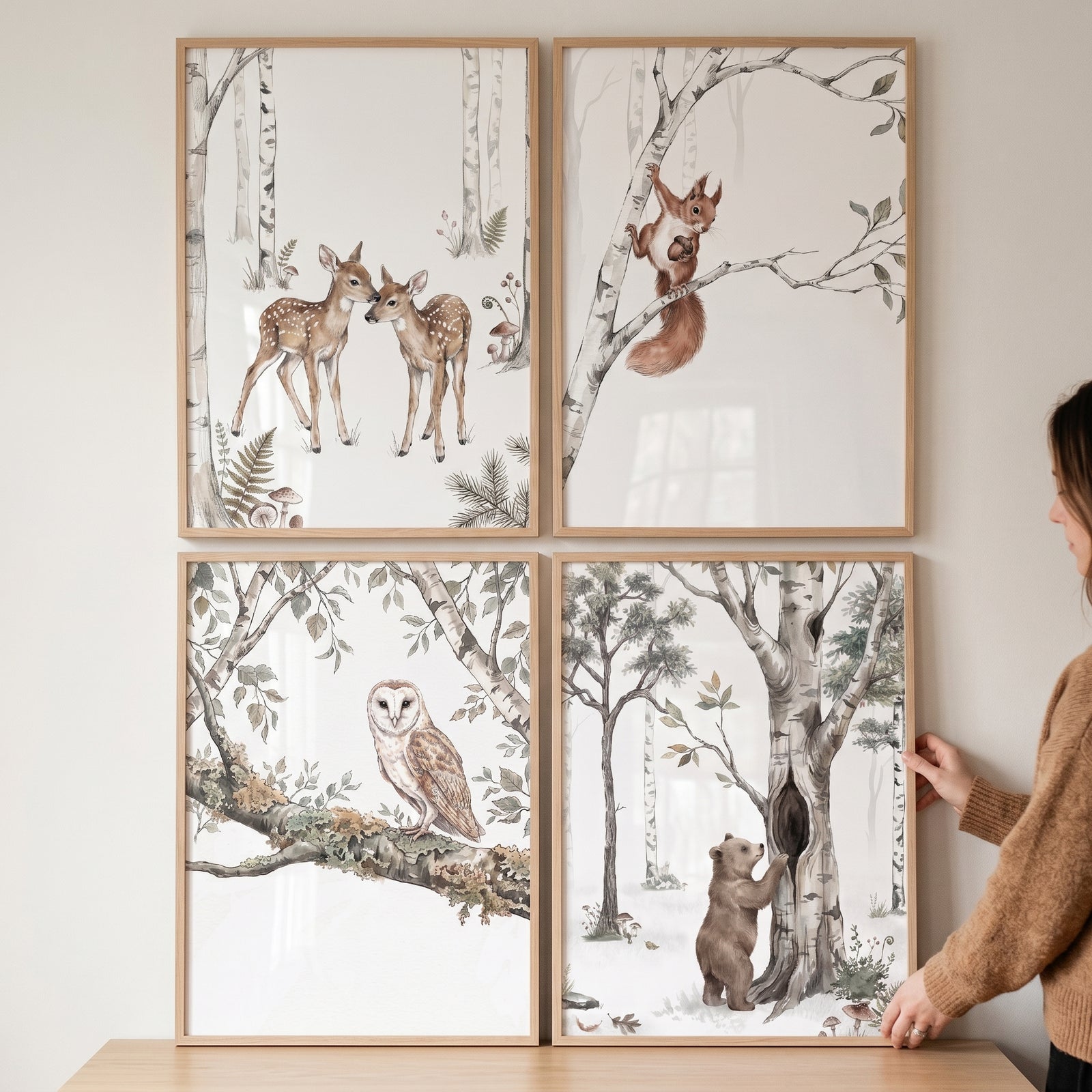 Birch grove animals wall art set of 4 with framed prints of deer, a squirrel, an owl, and a bear in birch trees.