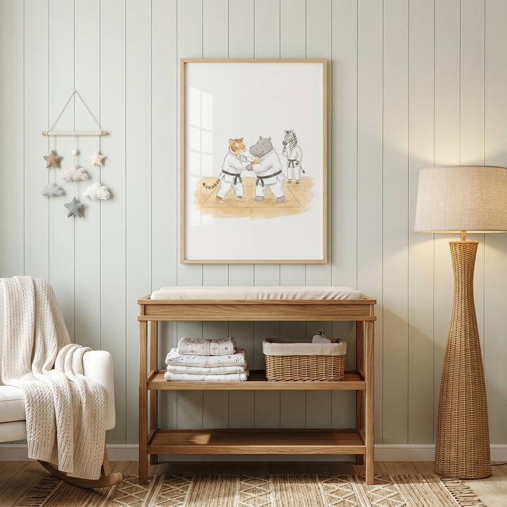 Nursery featuring a changing table, floor lamp, and framed black belt judo animals artwork on wood-paneled walls.