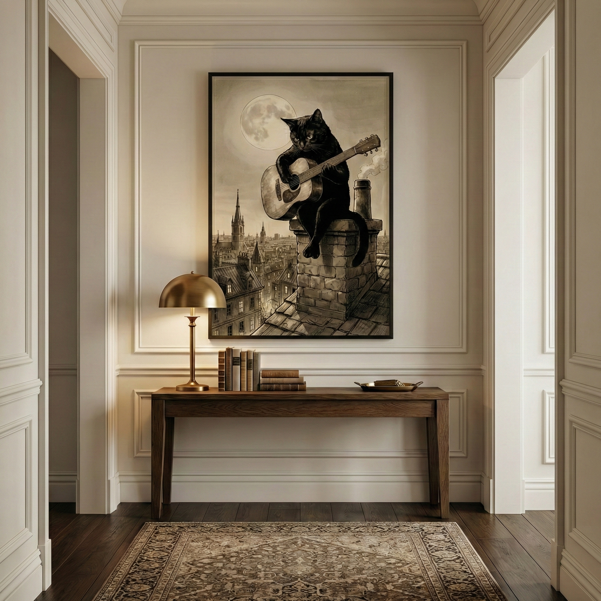 An elegant hallway featuring a framed illustration of a black cat perched on a chimney, playing an acoustic guitar under a large full moon overlooking a city. The artwork hangs above a dark wood console table decorated with a brass lamp and antique books. The room has white wainscoting, dark hardwood floors, and a classic patterned rug. The scene is viewed through a doorway, emphasizing a sophisticated yet playful interior design style.