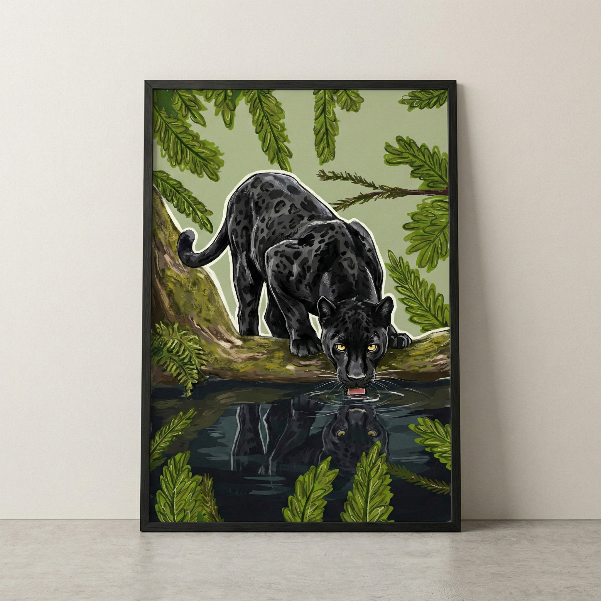 A vertical artwork of a large, melanistic feline with subtle dark spots and glowing golden eyes. The sleek animal is perched on a mossy log, leaning down to drink from a dark pool of water. Its reflection is clearly mirrored in the still water. The central figure is highlighted with a fine white outline and surrounded by lush green leaves and ferns against a soft sage-green background. The piece is presented in a slim black frame on a plain, light-colored wall.