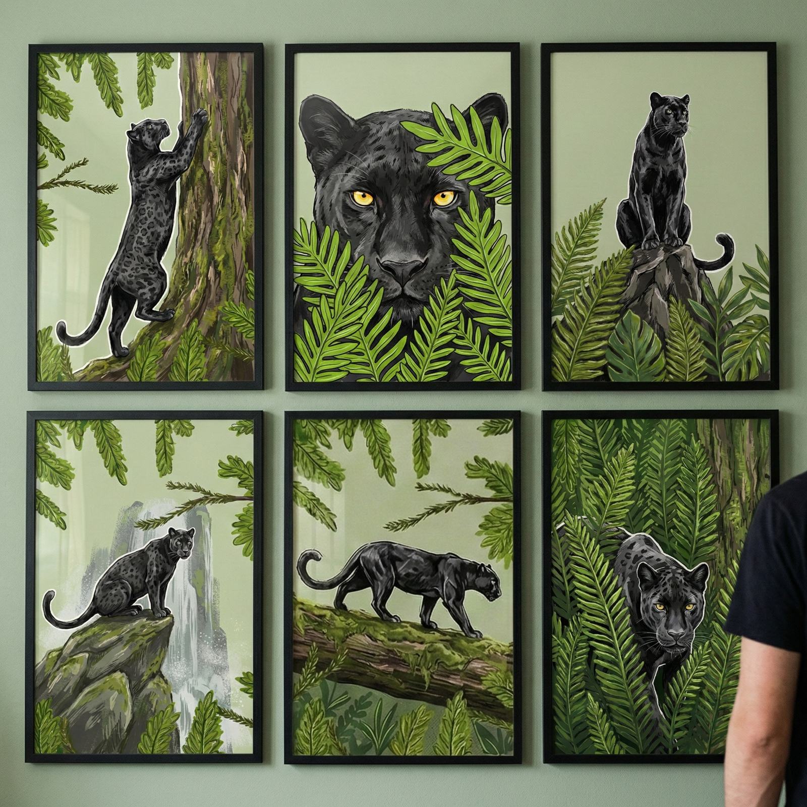 An eye-level shot shows a gallery wall featuring six black-framed illustrations of black panthers in various jungle-themed settings. The wall is a soft sage green, and the frames are arranged in two rows of three. In the top row, the left image depicts a black panther climbing a thick, textured tree trunk. The middle image is a close-up of a panther's face with striking yellow eyes peeking through vibrant green ferns. 