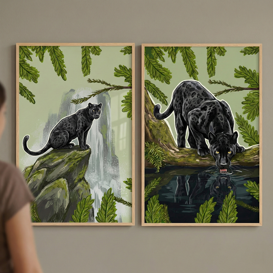 Two framed digital illustrations of black panthers are mounted on a neutral wall. In the left frame, a sleek jungle cat with subtle spots sits on a mossy rock formation in front of a misty waterfall. In the right frame, the panther is perched on a tree branch, leaning down to drink from a pool of water that shows its reflection. Both scenes feature lush green jungle foliage and a light-colored sky. The feline subjects have a white outline. A person is partially visible on the far left.