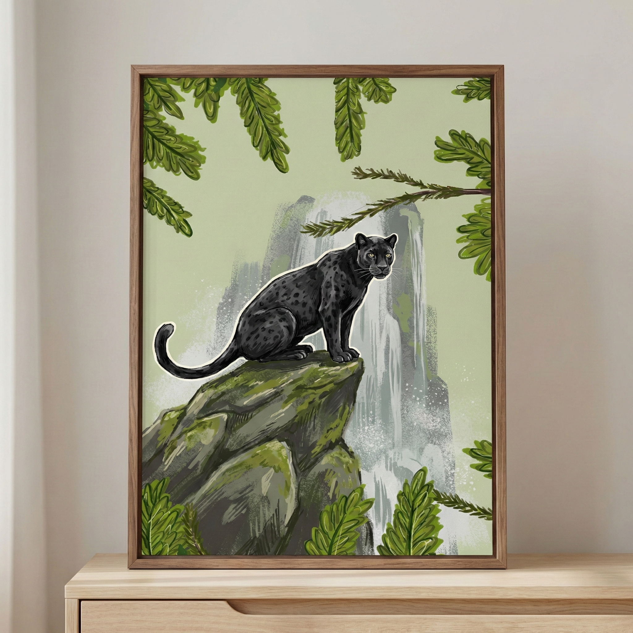 This framed illustration showcases a black leopard with subtle rosettes, perched atop a mossy boulder. A misty waterfall flows in the background, set against a soft green sky. Lush, green fern-like leaves frame the top and bottom of the composition. The artwork is presented in a slim wooden frame, resting on a light-toned wooden tabletop. The style is a clean digital rendering with detailed textures on the animal and natural elements.