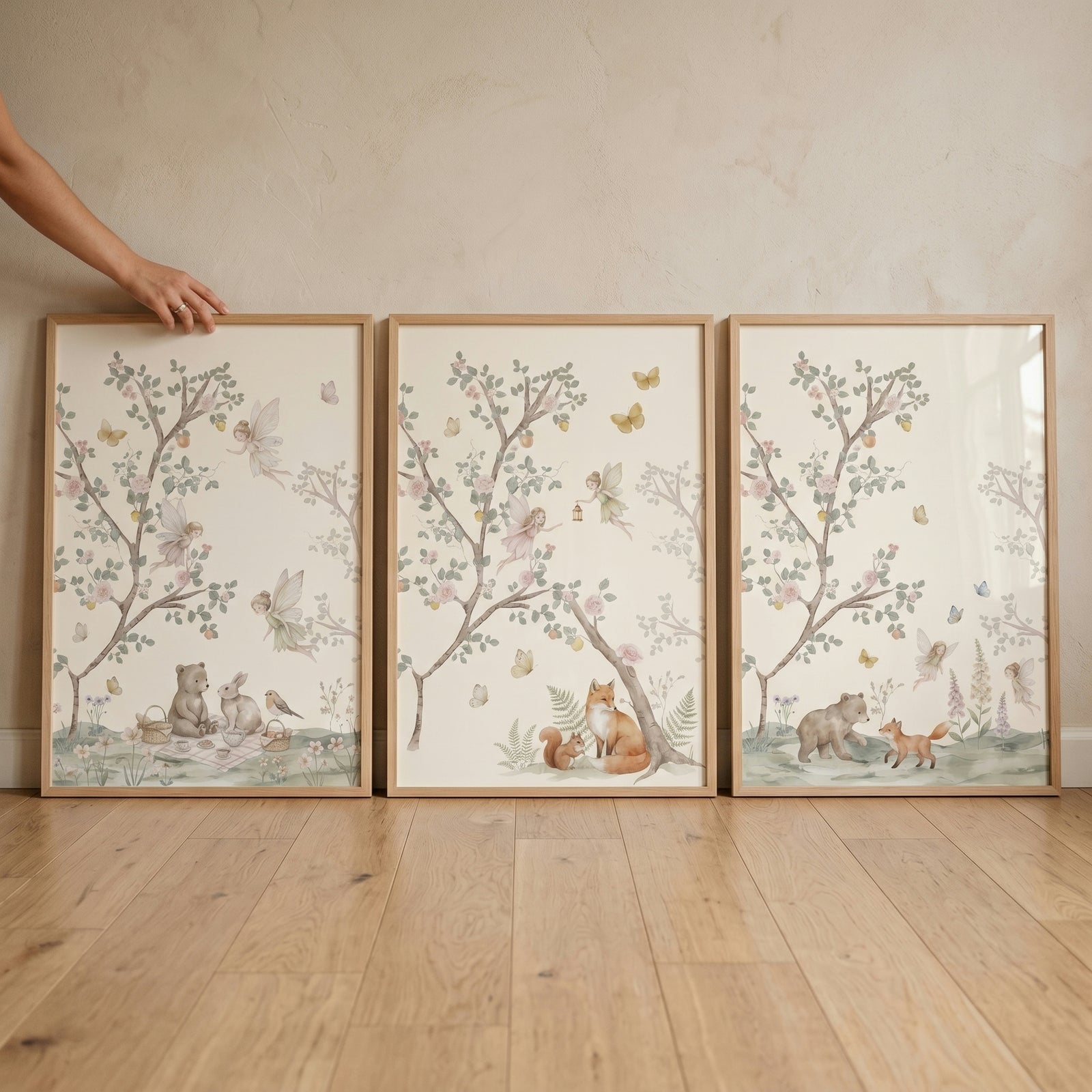 Blossom branch woodland fairies wall art set of 3 with whimsical watercolor forest animals in light wood frames.