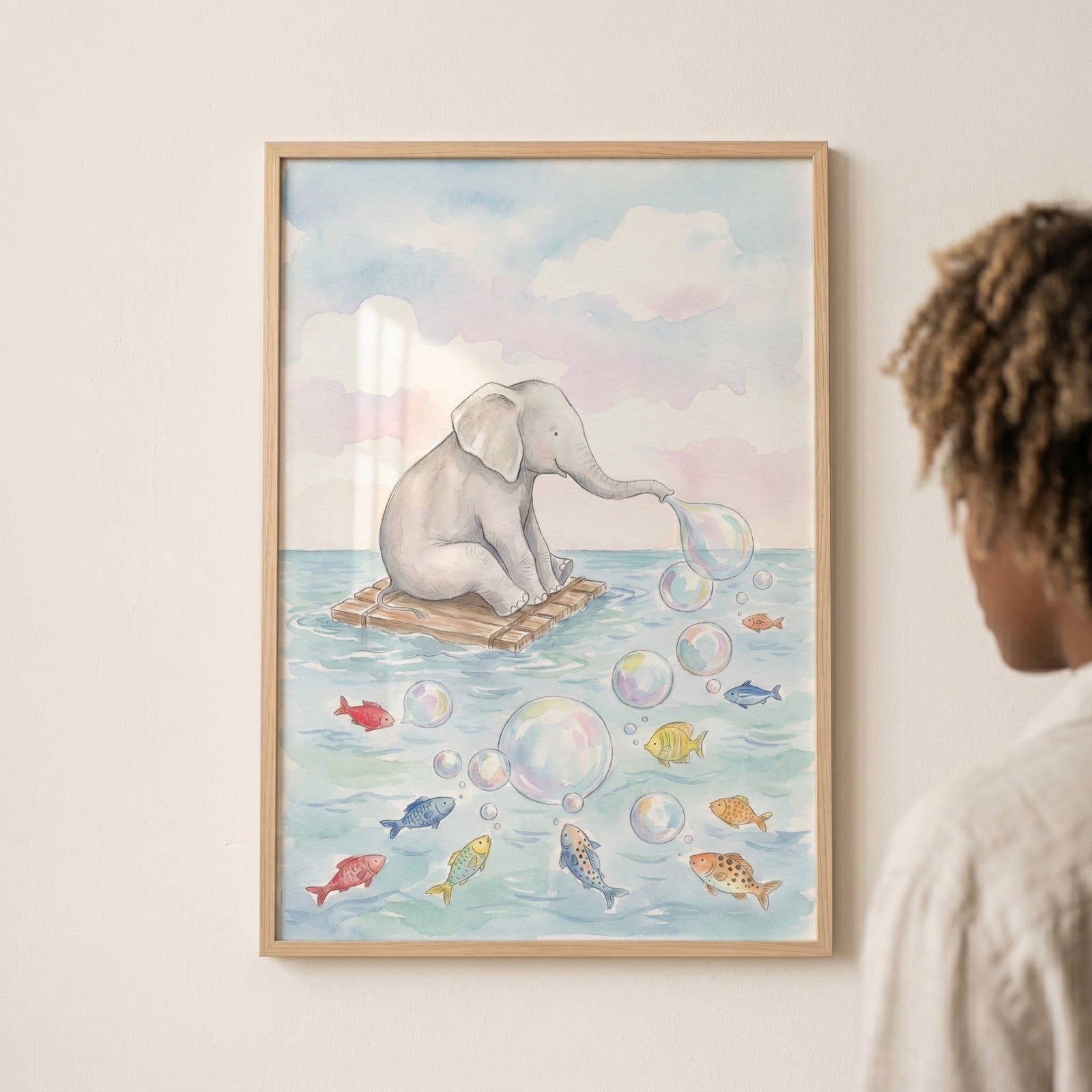 Framed blowing bubbles baby elephant wall art depicts an elephant on a raft at sea with bubbles and colorful fish.