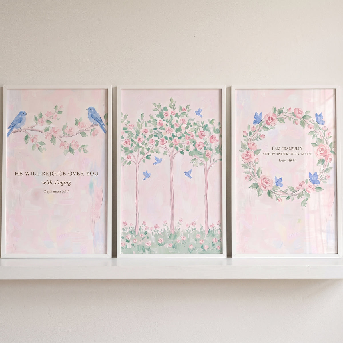 Blue accent pink garden wall art set of 3 featuring blue birds, floral trees, and a wreath with scripture verses.