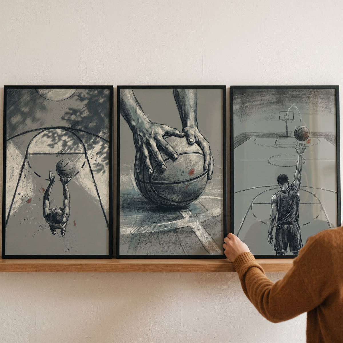 Blue basketball player sports wall art set of 3 on a shelf, featuring monochromatic sketches of ball handling and shooting.