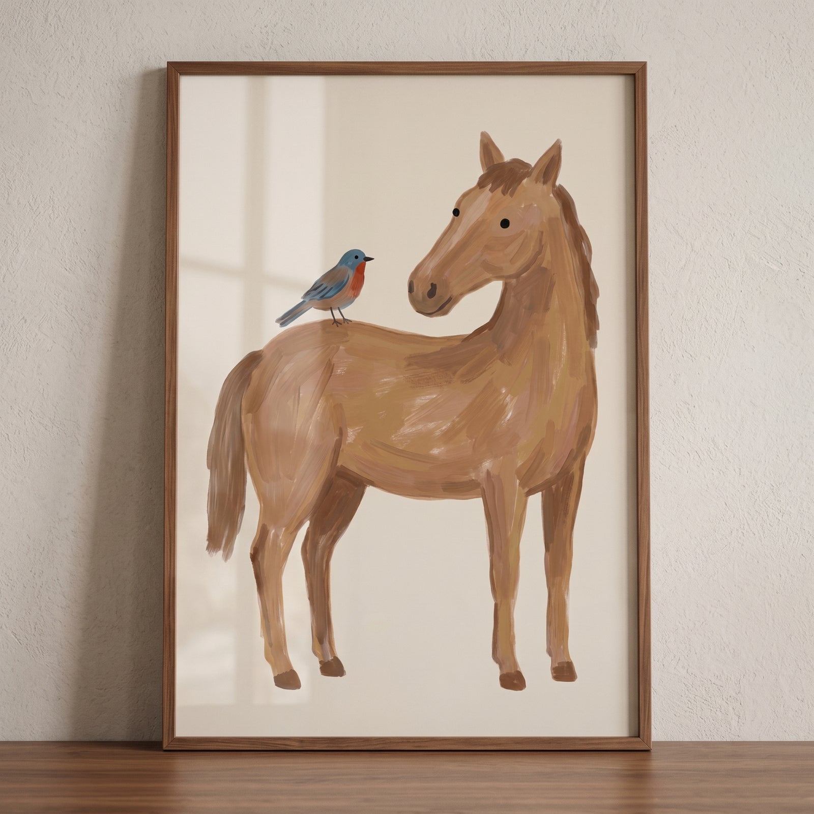 Framed blue bird brown horse wall art features a brown horse looking back at a small blue bird perched on its back.